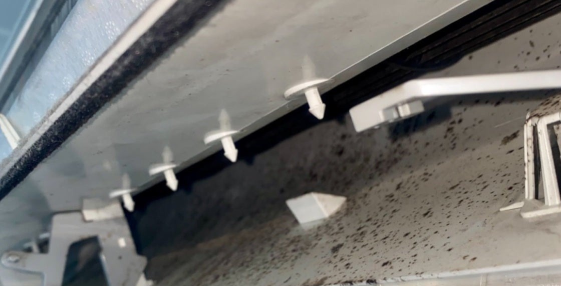 Inside a Gold Coast split system before cleaning, showing heavy mould speckling across the surface